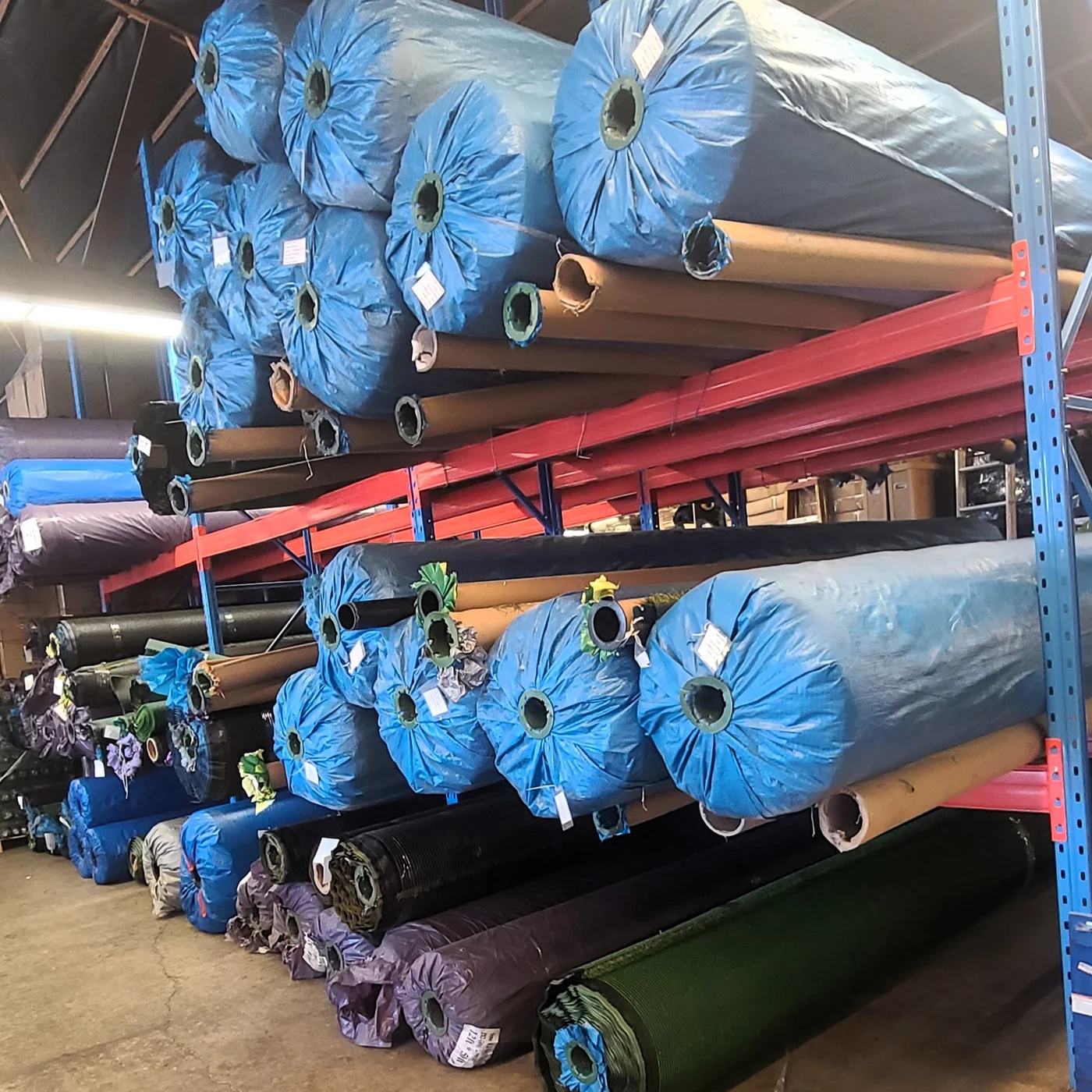 Artificial turf rolls stored in a warehouse